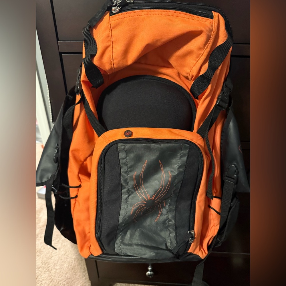 Orange and Black Spyder snow backpack.